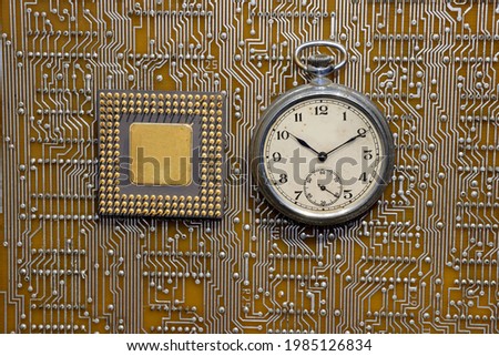 computer chip on circuit board and pocket watch