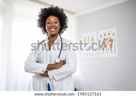 Medical concept of young beautiful female doctor in white coat with phonendoscope, waist up. Woman hospital worker looking at camera and smiling, office, grey background