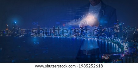 Businessman using smartphone with analysis data and graph to development for business plan in the future with double exposure city and blue background
