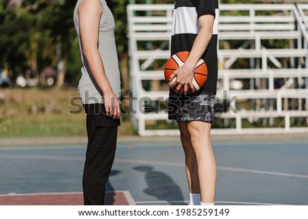Sports and recreation concept two opposite players facing before the basketball game starting.