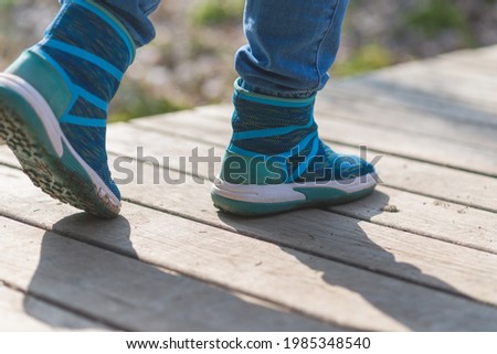 woman walk in to the wild. Travel adventure and freedom concept.Woman walking outdoors, shoes closeup