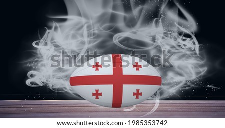 Compostion of rugby ball of georgia flag on black background with white smoke. championships, sports and competition concept digitally generated image.