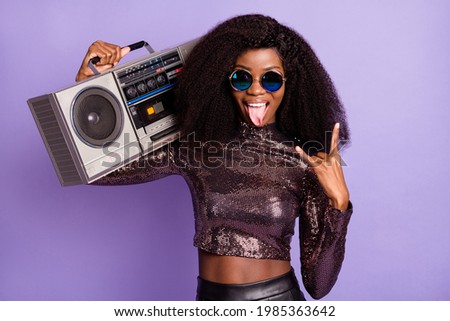 Photo of lady hold radio tongue out show horns wear retro sunglass glossy shirt isolated violet color background