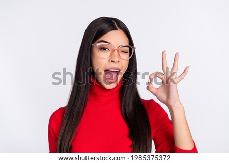 Photo of young happy excited funky charming asian girl show okay sign winking eye isolated on grey color background