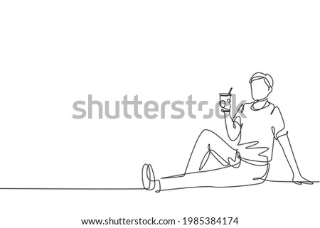 Continuous one line drawing young man sitting relaxed in the park enjoying a cup of hot coffee and fresh natural scenery. Happy lifestyle concept. Single line draw design vector graphic illustration