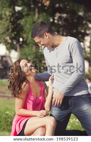 Young couple in love, together in the park 