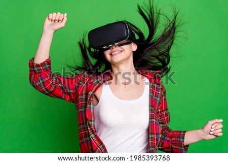Photo of optimistic brunette hairdo young lady play game wear eyewear red shirt isolated on green color background