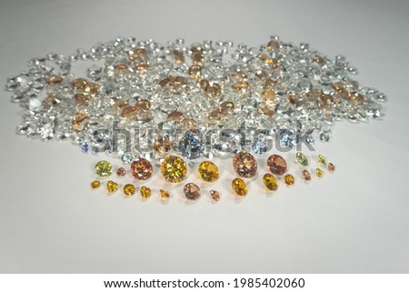 
A group of Golden diamonds arranged in a row in front of white diamonds on a white background.
