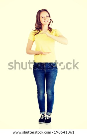 Happy , excited young woman presenting copy space on her palm