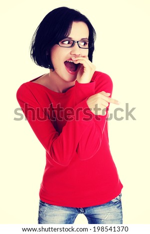 Happy , excited young woman pointing on copy space