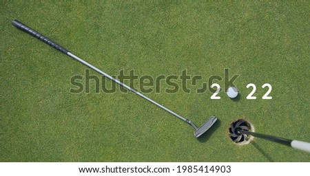Composition of 2022 number with golf ball and golf club on golf course. sports calendar and competition concept digitally generated image.