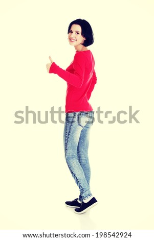 Beautiful young woman in casual clothes gesturing thumbs up.