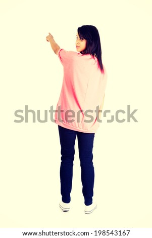 Happy , excited young woman pointing on copy space.