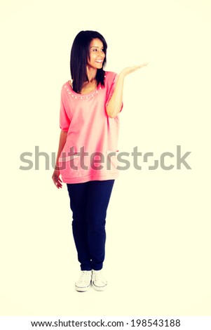 Happy , excited young woman presenting copy space on her palm