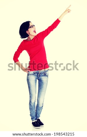 Happy , excited young woman pointing on copy space