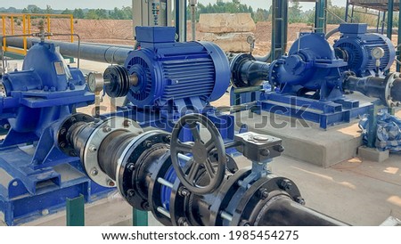 Electric motors driving water pumps of water system. Royalty-Free Stock Photo #1985454275
