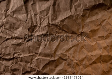 crumpled paper. sheet of brown cardboard paper. detailed high resolution texture. abstract background for wallpaper.