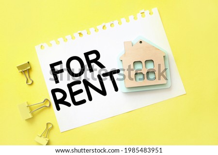 Red For Rent Real . text on white paper on yellow background. with a picture of a wooden house