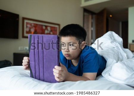 asian chinese boy playing smartphone, kid use phone and play game, addicted game and cartoon
