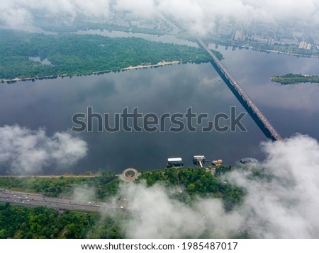 High view of the Dnieper River in Kiev through the clouds. Spring cloudy morning. Aerial high view.