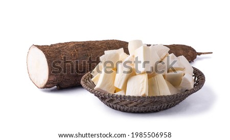cassava or manihot, also known as manioc, yuca or brazillian arrowroot, root vegetable cut into pieces ready for cooking with a half cut root, on white background
