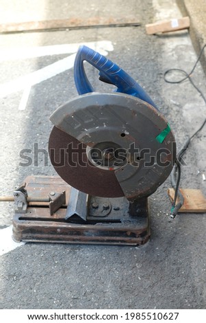 cutting steel metal with rotating carbon blade cutter. Steel industry and workshop concept.