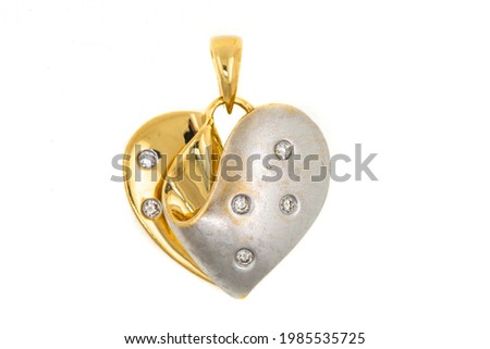 Gold heart-shaped pendant. The jewelry is isolated on a white background. Falling in love. Expensive jewelry, precious