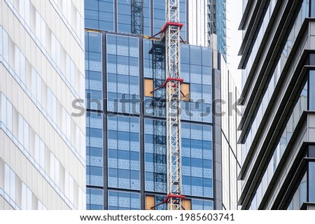 Crane attached to side of building, construction site, high crane