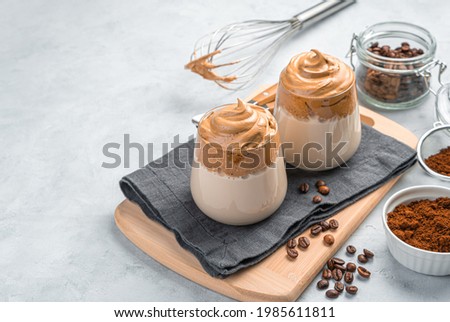 Coffee dessert, whipped foam and milk on a gray background. A traditional Korean drink. Side view, copy space. Royalty-Free Stock Photo #1985611811