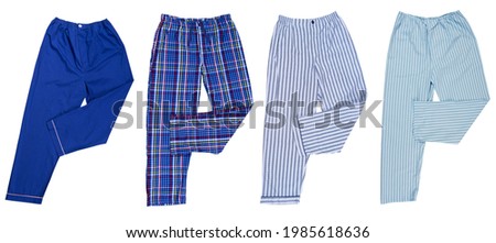 Set of sweatpants isolated on a white background, Different pants for sleep pajamas set isolated on white background, checkered and striped Pajama Pants Isolated on a White Background Royalty-Free Stock Photo #1985618636