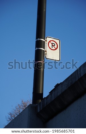 No parking sign on a pole, taken from below. 