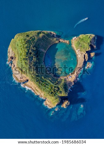 Azores aerial panoramic view. Top view of Islet of Vila Franca do Campo. Crater of an old underwater volcano. San Miguel island, Azores, Portugal. Heart carved by nature. Bird eye view. Royalty-Free Stock Photo #1985686034