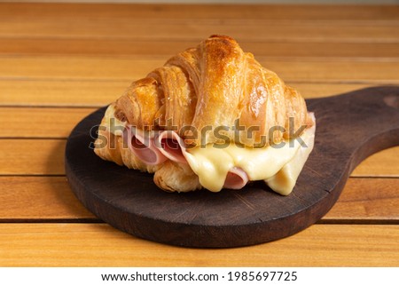 
croissant with ham and melted cheese Royalty-Free Stock Photo #1985697725