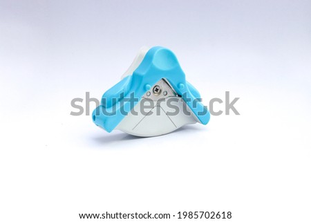 Blue and white corner cutter rounder punch for cutting card photo paper. Isolated on white background.