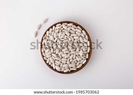 Navy bean On a wooden plate on a white background