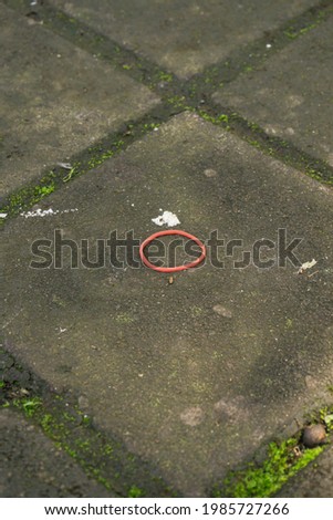 abstract background, red rubber on the garden floor,