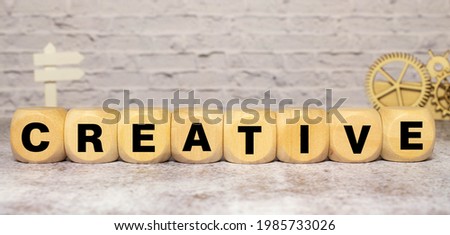 Creative word on wooden cubes over blur background, success in business concept.