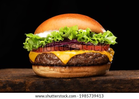 salad cheese burger on wood plate with black background Royalty-Free Stock Photo #1985739413
