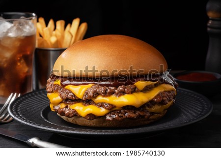 smash burger cheese on black plate cheddar  Royalty-Free Stock Photo #1985740130