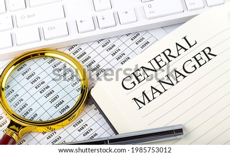 GENERAL MANAGER text on the notebook with chart, magnifier,keyboard and pen