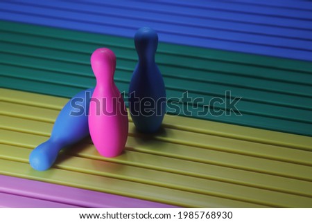 Miniature bowling poins in a colorful background