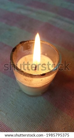 candle flame burning in a glass