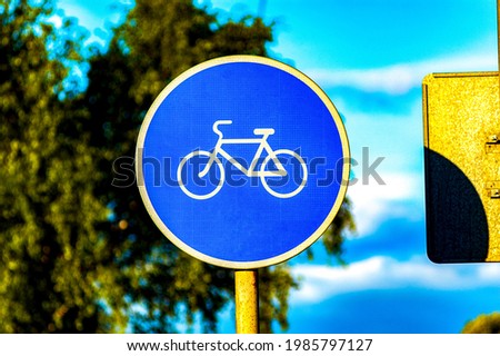 Bicycle path road sign. Bicycle traffic signpost in the city. Eco-friendly mode of transport. The concept of a healthy lifestyle, sports, the fight against exhaust gases of cars. 