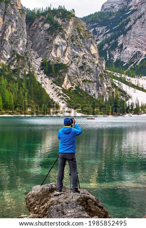 Photographer at work on Lago di Braies in the Dolomite Alps
