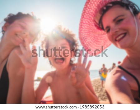 Blurred family photo. Happy family is on vacation on the beach with a beautiful view of blue sky and sun