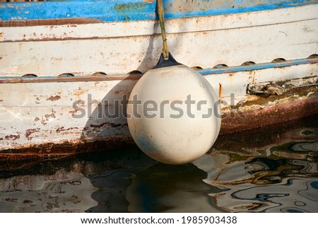 particles of shockproof buoys on the wooden fishing boat hull