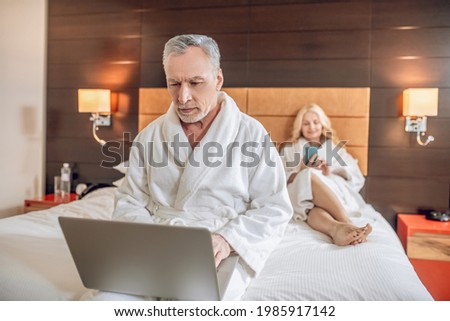 Couple in bath robes spending a day together and feeling relaxed
