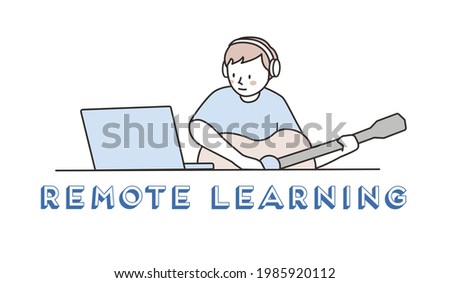 A man with headphone playing guitar while watching online guitar music lesson on notebook computer. Remote education or learning.