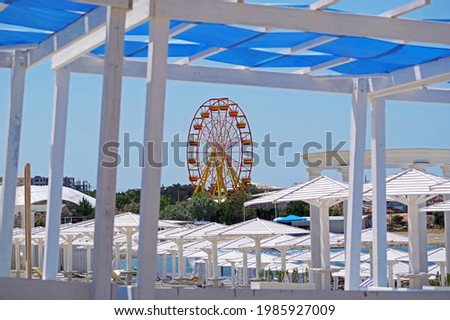 Sea beach with sand and long row of wooden umbrellas