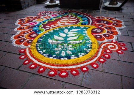 Close up of the Kolam in the Indian temple. Kolam is a form of drawing that is drawn by using rice flour, chalk, chalk powder or rock powder.